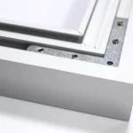 Close-up of a silver aluminum frame with screws and layered inner panels on a white background.