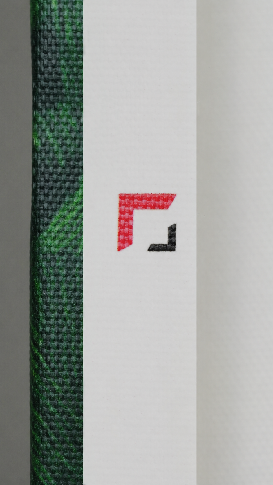 Close-up of the company logo printed on the back of a 2 cm canvas