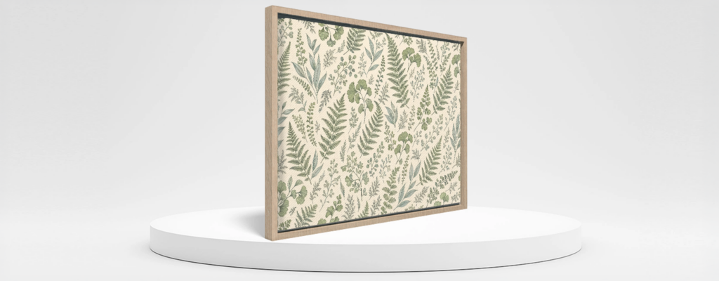Framed canvas wall art with botanical artwork and a light wood-look frame on a white podium
