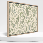 Framed canvas wall art with botanical artwork and a light wood-look frame on a white podium