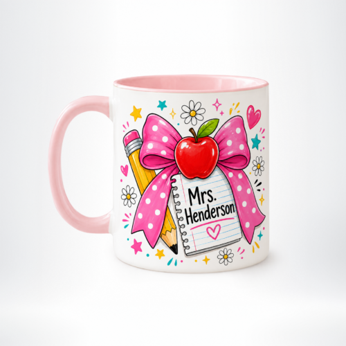Inner Colored Mug • merchOne White mug with pink interior and handle featuring a colorful school-themed design, including a large pink bow, pencil, and a notebook labeled • merchOne'Mrs. Henderson'
